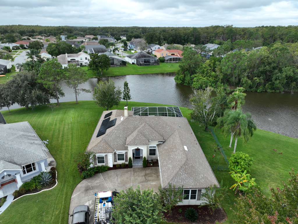 aerial-view-residential-house-lake-solar-panels-greenery